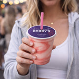 Person holding a pink smoothie with a custom printed cup toppers Hermosa Beach cup